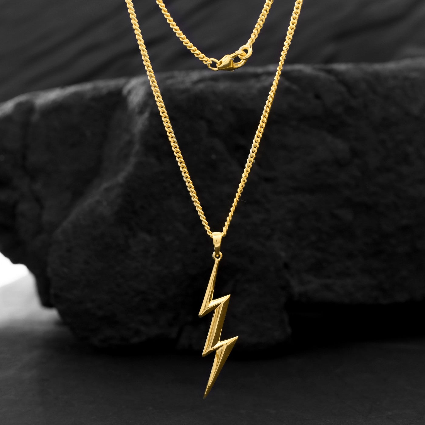 For the person who embraces their inner storm, a gold lightning bolt pendant for men on a sleek chain. pen_spark