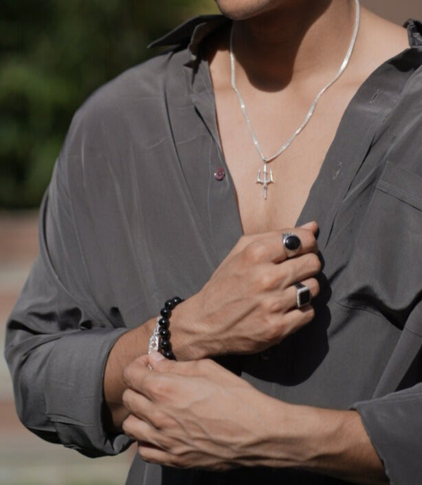 A black bracelet with round beads. This classic piece of jewelry is perfect for everyday wear