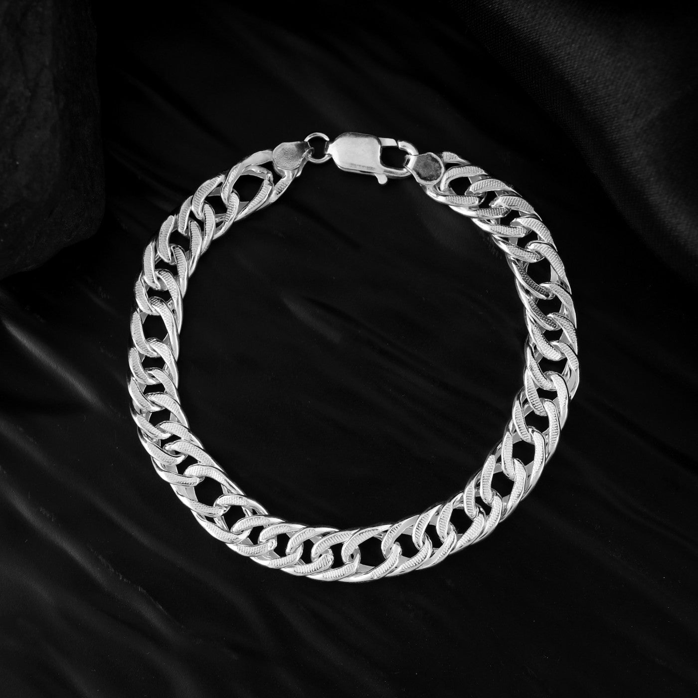 This image showcases a pure silver charm bracelet for men with a clasp. A perfect gift for the man who appreciates understated elegance. 