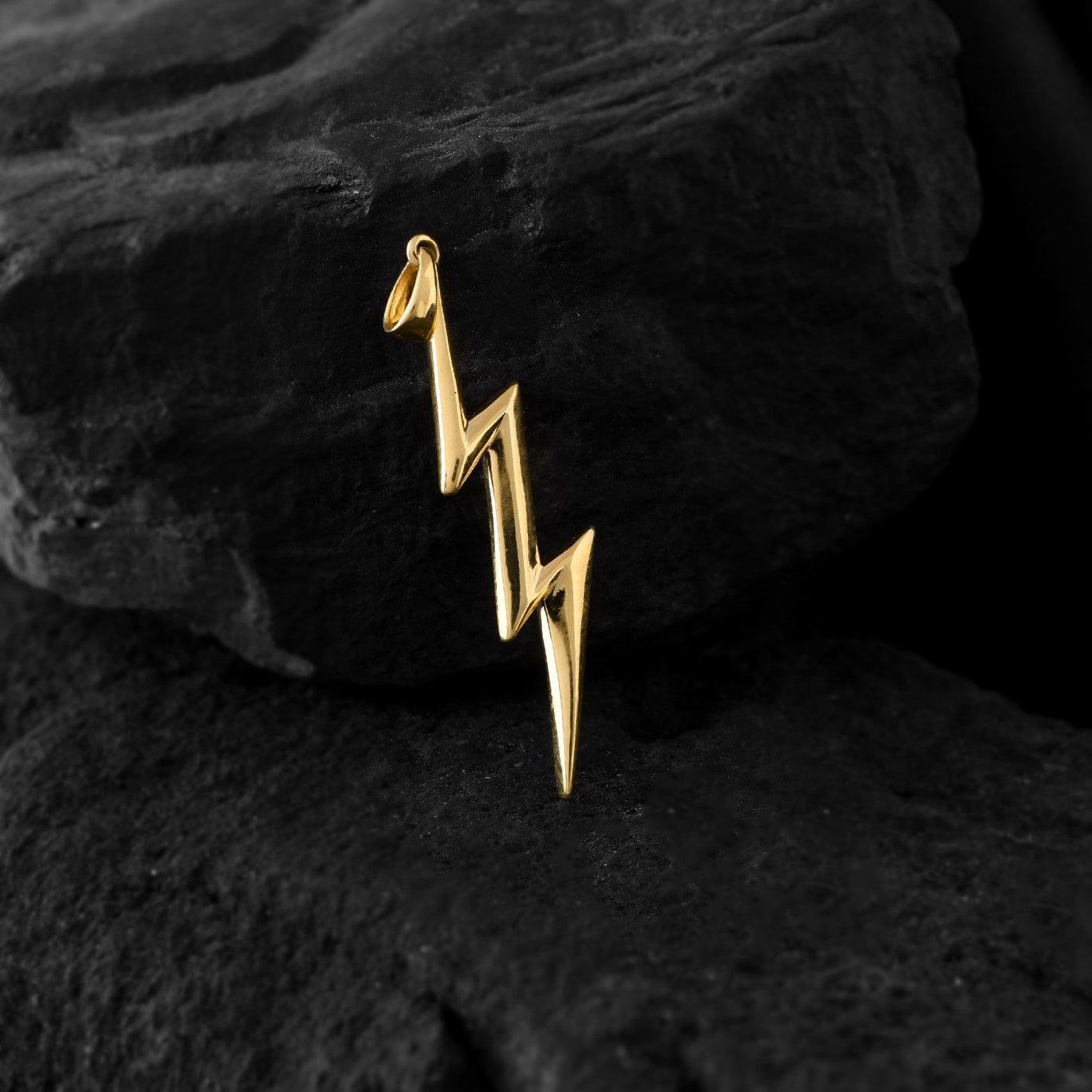 Energy in gold. This striking lightning bolt pendant, crafted from precious metal, symbolizes raw power and the spark of inspiration that ignites creativity.