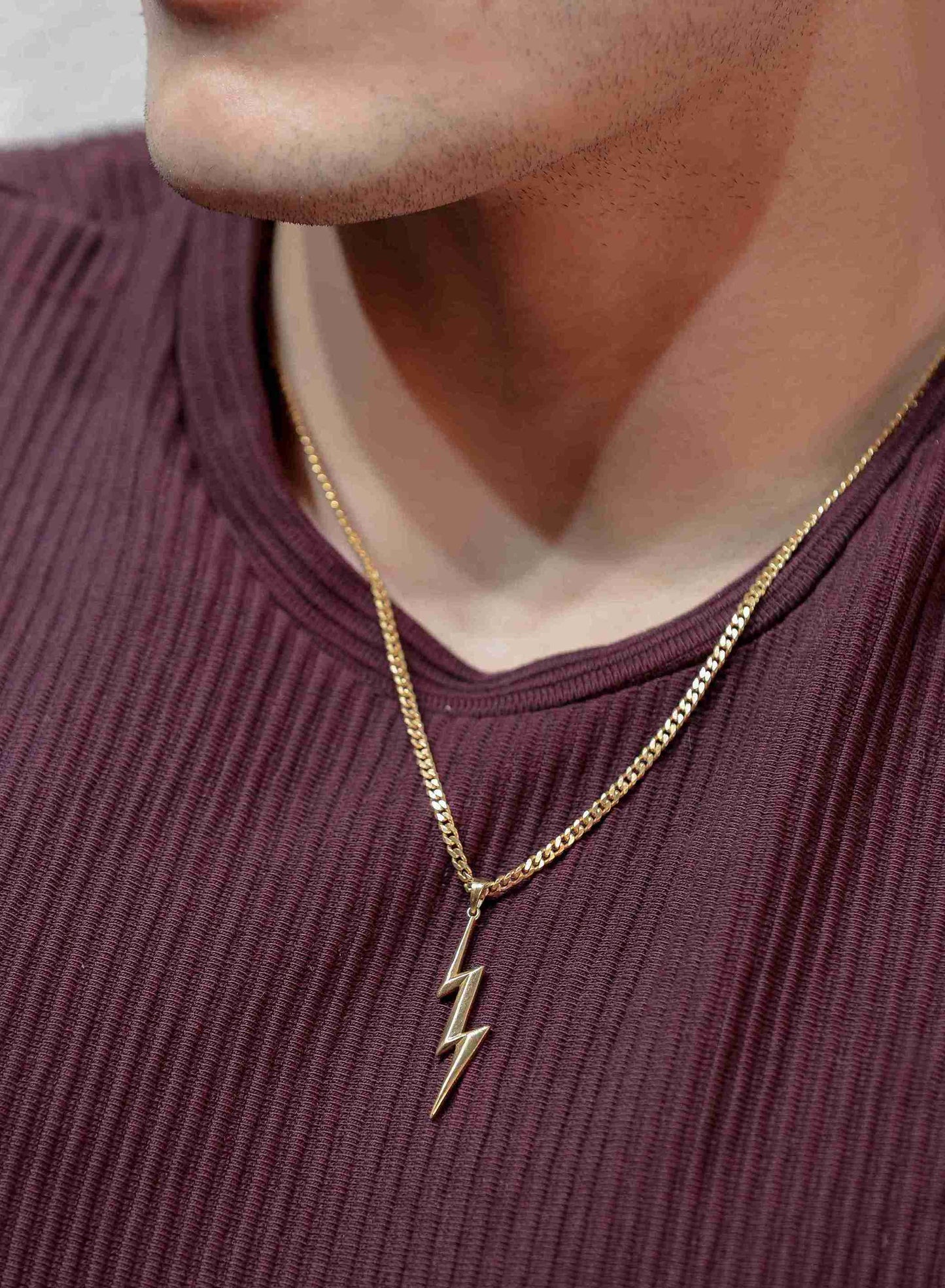 Golden spark! This lightning bolt pendant for men, crafted in gleaming gold, channels the electrifying power of a storm. 