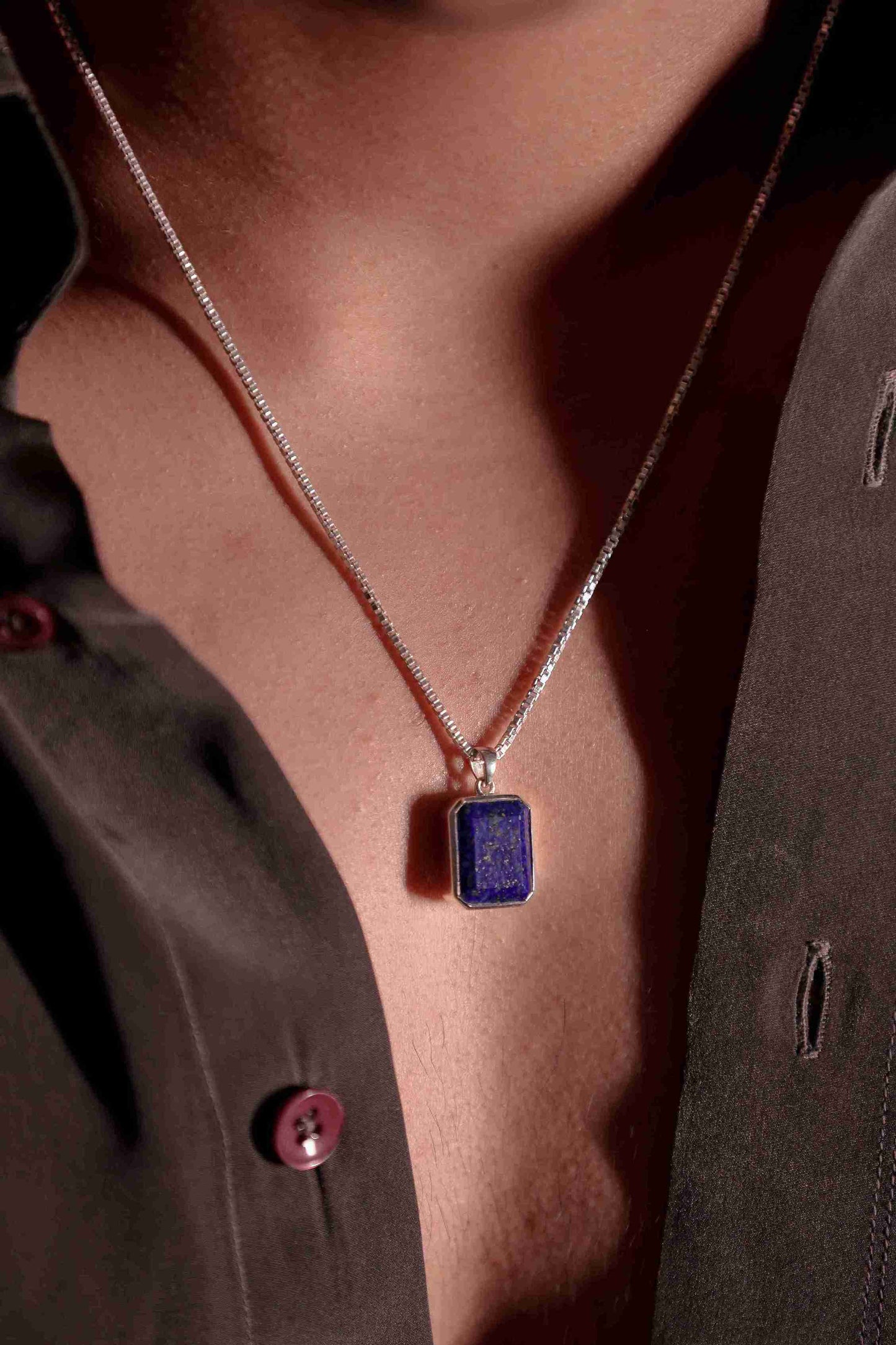 Crafted lapis stone silver pendant for men. The gemstone's deep blue color and pyrite flecks are elegantly framed in gleaming 925 sterling silver.