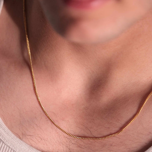 Luxurious gold link chain necklace, showcasing the intricate details of each polished link. The classic design makes it a timeless piece of gold jewelry for men