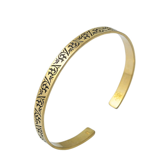 Crafted from 18k gold plated, a stunning mens cuff bracelet featuring a blooming floral design rests on a white background.