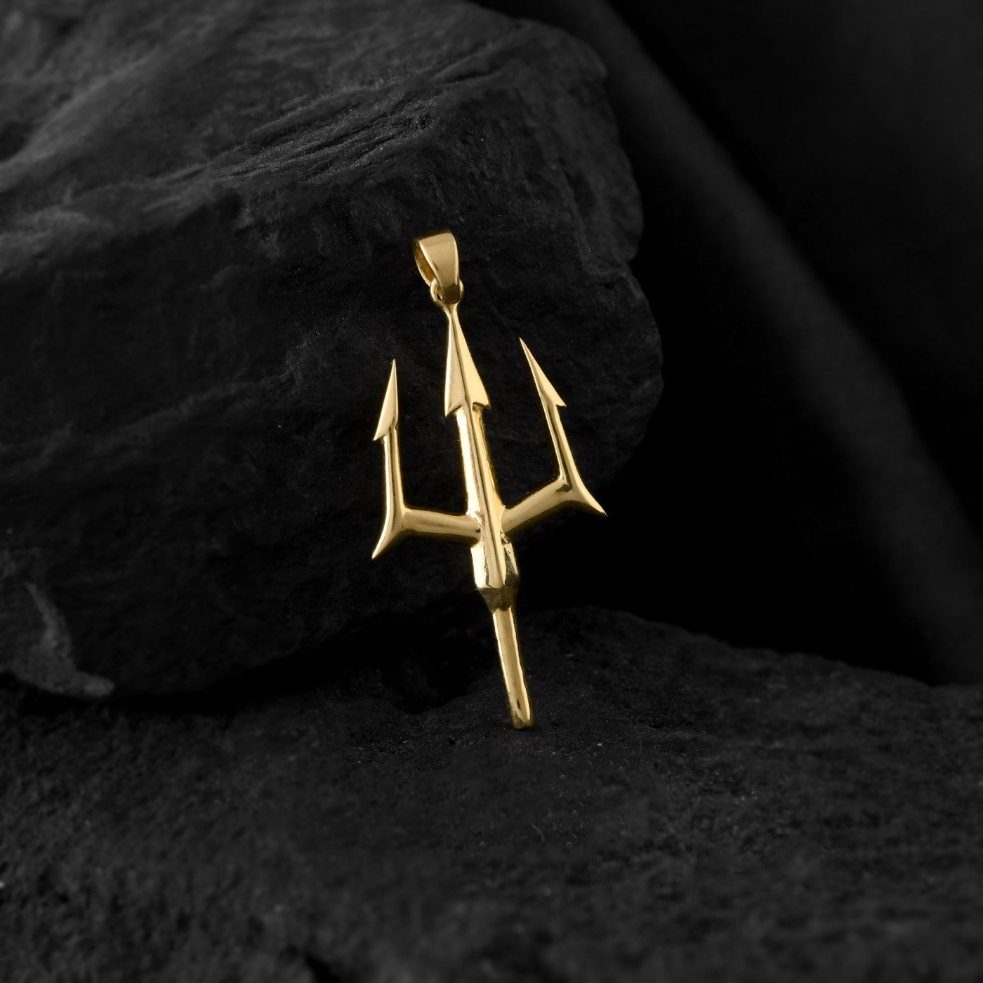 A gold men's necklace featuring a trident pendant. The trident is a symbol of strength and power in Greek mythology.