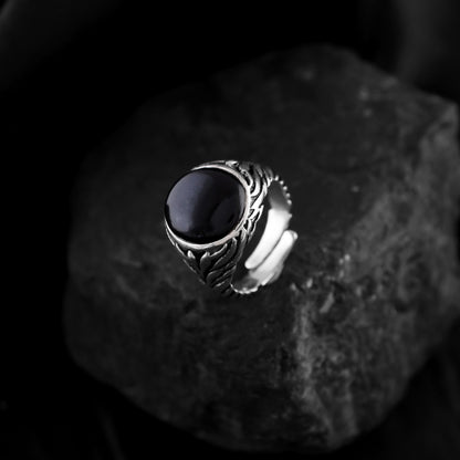 A black onyx gemstone ring crafted from sterling silver. This classic men's ring features a smooth black stone and a polished silver band.