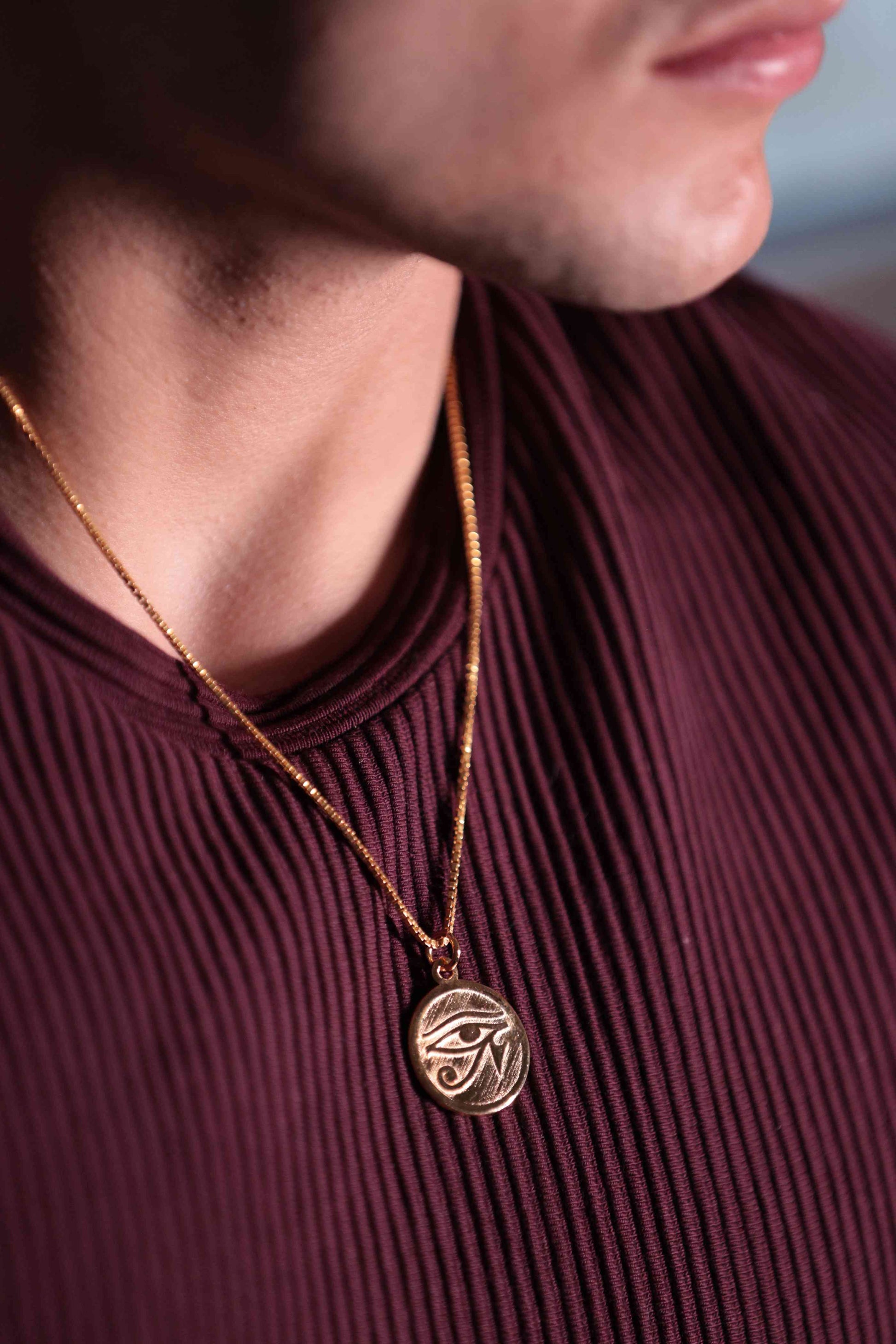 Gleaming gold pendant showcases the Eye of Horus, a powerful symbol from ancient Egypt representing good health, wisdom, and protection from harm