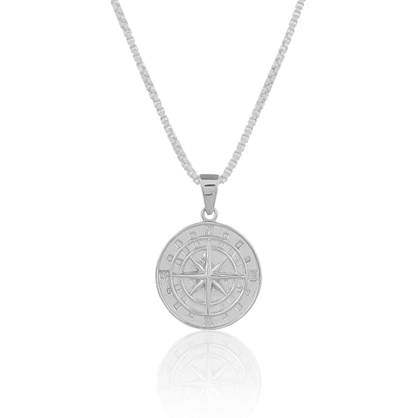 A silver necklace with a compass pendant hangs on a white background. The compass is a symbol of guidance, direction, and finding your way. 