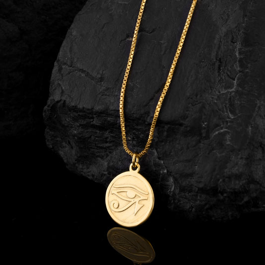 Worn as an amulet for centuries, the Eye of Horus on this gold necklace symbolizes protection, healing, and kingly power in ancient Egyptian mythology.